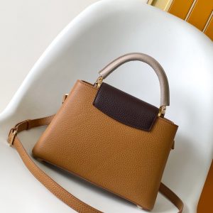 Alternative view of p115031.05 x 20.0 x 11.0 cm (L x H x W) 27.0 x 17.3 x 9.0 cm (L x H x W) 21.0 x 13.6 x 8.0 cm (L x H x W) • Taurillon calf leather • Calf leather trim •Cowhide leather lining•Metal hardware•Flap can be positioned inside or outside•Zippered interior pocket•Interior slip pocket•Metal studs•Holds smartphone, LV Vertical wallet, headphones, and keys•Strap: Detachable, adjustable•Strap half-length: 45.5 cm•Strap half-length adjustable to: 53.0 cm•Handle: Single handle